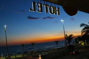 a view of the beach at sunset from a building at Sol Ipanema Hotel in Rio de Janeiro