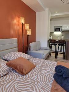 a bedroom with a bed and a living room at Les Fontaines in Besançon
