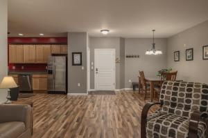 a living room and kitchen with a couch and a table at 2 Bedroom Mountain View Condo with Private Hottub in Girdwood