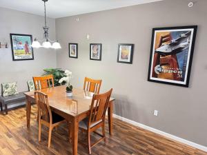 a dining room with a wooden table and chairs at 2 Bedroom Mountain View Condo with Private Hottub in Girdwood