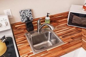 a kitchen counter with a stainless steel sink at Historic Downtown Deco Queen Studio in Anchorage
