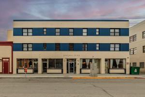 a blue and white building on a city street at Historic Downtown Deco Queen Studio in Anchorage