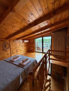 a room with a bed in a wooden cabin at Sara Riverside Cottage in Ulcinj