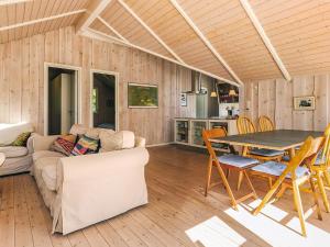 a living room with a couch and a table at 4 star holiday home in Græsted in Græsted