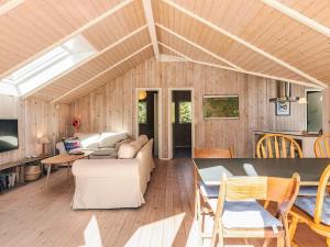a living room with a couch and a table at 4 star holiday home in Græsted in Græsted