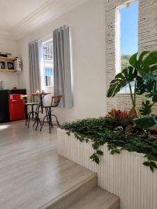 a living room with a table and some plants at Suíte Garden em Butantã Próximo á USP - Self Check-in in São Paulo