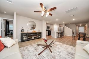 a living room with a couch and a ceiling fan at Modern Living, Close to Everything in Houston +13 photos