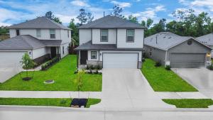 a large house with a driveway in a yard at Modern Living, Close to Everything in Houston