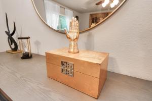 a box sitting on top of a table with a mirror at Modern Living, Close to Everything in Houston
