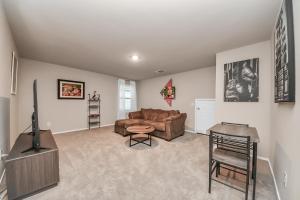 a living room with a couch and a chair at Modern Living, Close to Everything in Houston