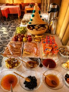 a table with many different types of food on it at Sahara Desert Apartment with Camel Tours & Free WiFi in Merzouga
