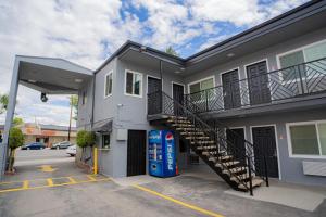 a building with a gas pump in a parking lot at Flamingo Motel near Universal Studios in North Hollywood