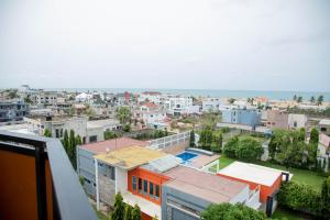 a view of a city with buildings and the ocean at Atlantic Beach Hôtel Bénin in Cotonou