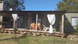 a house with a deck with a table and chairs at Veraniega in Playa Hermosa