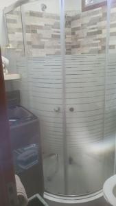 a glass shower in a bathroom with a sink at Veraniega in Playa Hermosa