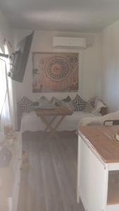 a room with a bed and a table in it at Veraniega in Playa Hermosa