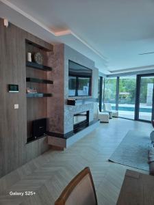 a living room with a fireplace in a house at The Bunica Residence in Parila