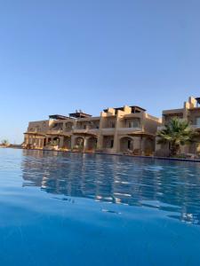 a large swimming pool in front of a building at Sina Cave in Dahab