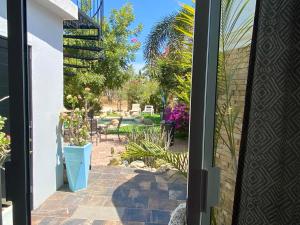 an open door to a patio with a table and chairs at Tropical Oasis in San José del Cabo
