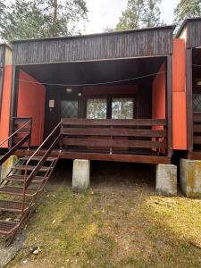 a small building with a bench in the front at Šiška Kemp in Doksy