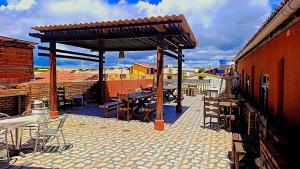 a pavilion with a table and chairs on a patio at Hospedagem Terral Beach Canoa Quebrada in Aracati