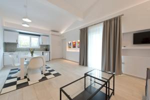 a kitchen and living room with a table and chairs at Votsalo Suites in Skala Potamias