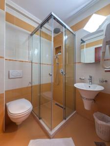 a bathroom with a shower and a toilet and a sink at Hotel Porto A in Ulcinj +71 photos