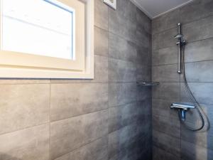 a bathroom with a shower with a window at Sluisje 55 in Kuinre