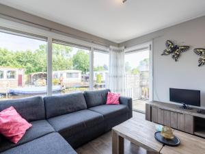 a living room with a couch and a tv at Sluisje 55 in Kuinre