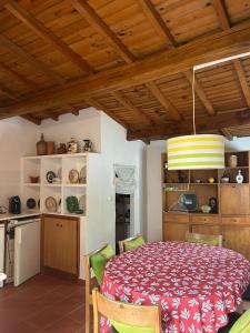 a kitchen and dining room with a table and chairs at Casa dos Cândidos in Alagoa