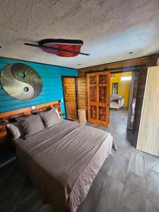 a bedroom with a bed with a fish on the wall at Bungalow Sugarcane in Saint-Louis