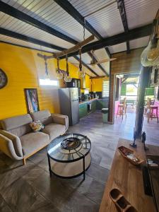 a living room with a couch and a table at Bungalow Sugarcane in Saint-Louis