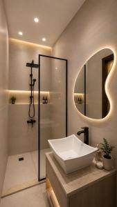 a bathroom with a sink and a shower and a mirror at Cacillion Pyramids View in Cairo