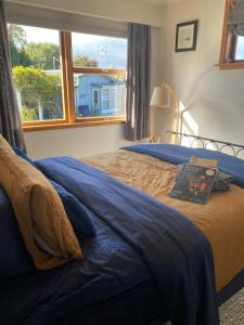 a bedroom with a large bed with a window at Right Side in Greytown