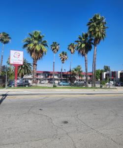 an empty street with palm trees in front of a building at SimpleStay Suites - Downtown San Bernardino in San Bernardino +17 photos