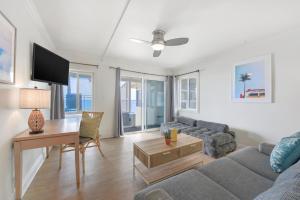 a living room with a couch and a table at Laguna Surf Lodge by SCP Hotels in Laguna Beach