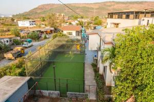 an overhead view of a tennis court in a city at Royal Heritage Lonavla - 7BHK with Turf in Lonavala