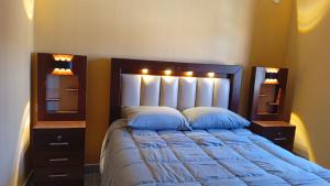 a bedroom with a large bed with two night stands at Luz de la puna in La Quiaca