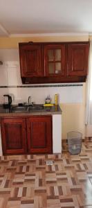 a kitchen with wooden cabinets and a wooden floor at Luz de la puna in La Quiaca