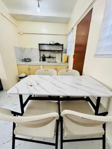 a table and chairs in a room with a kitchen at MiKasa Azul Transient House in Cabuyao