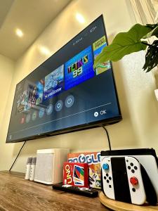 a table with a tv and a video game controller at Atelier Studio, Stanford Suites 3, Silang in Silang