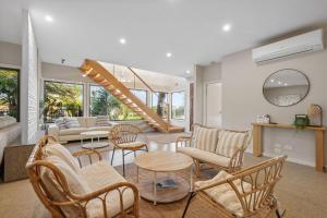 a living room with chairs and a spiral staircase at The Islander in Ventnor