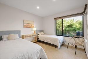 a bedroom with two beds and a window at The Islander in Ventnor +34 photos