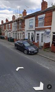 a black car parked on the side of a street at Quiet Nest 2 in Coventry