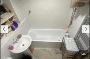 a bathroom with a white tub and a sink at Quiet Nest 2 in Coventry