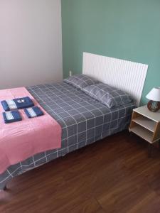 a bedroom with a bed and a night stand at Hotel Status in Jaguarão