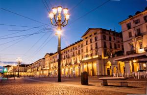 a street light in front of buildings at night at Lingotto Side House - Affitti Brevi in Turin