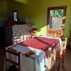 a dining room with a table and chairs and a window at El Rincón de la Quebrada in Tilcara +19 photos