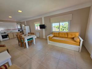 a living room with a couch and a table at Departamentos Atlantic in Monte Hermoso