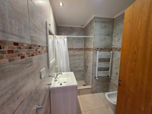 a bathroom with a sink and a shower at Departamentos Atlantic in Monte Hermoso +21 photos